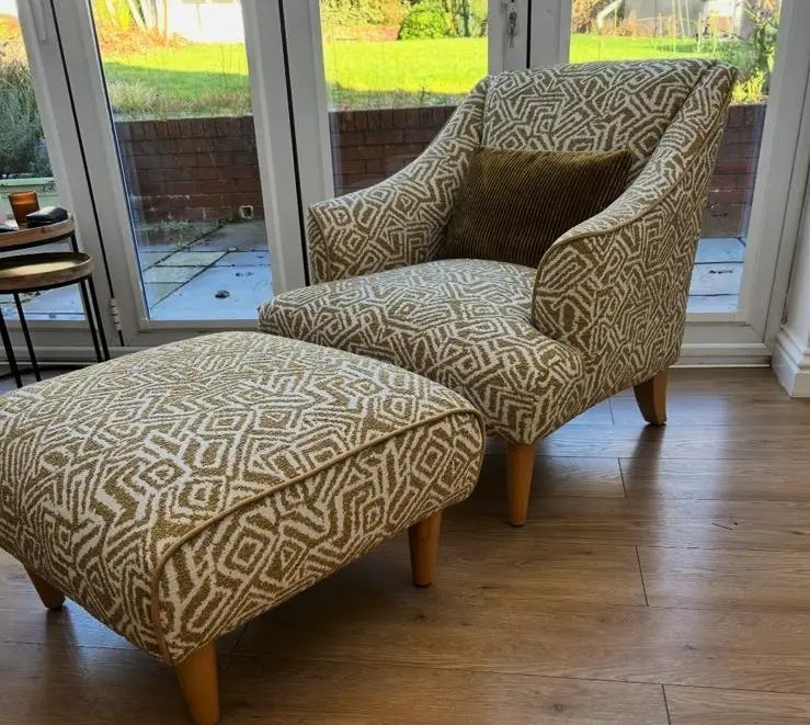 Wing armchair and footstool reupholstered in a geometric weave beside patio doors